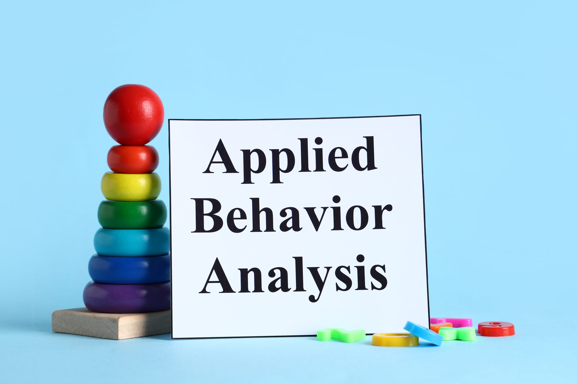 Applied Behavior Analysis sign beside a stacking-ring toy