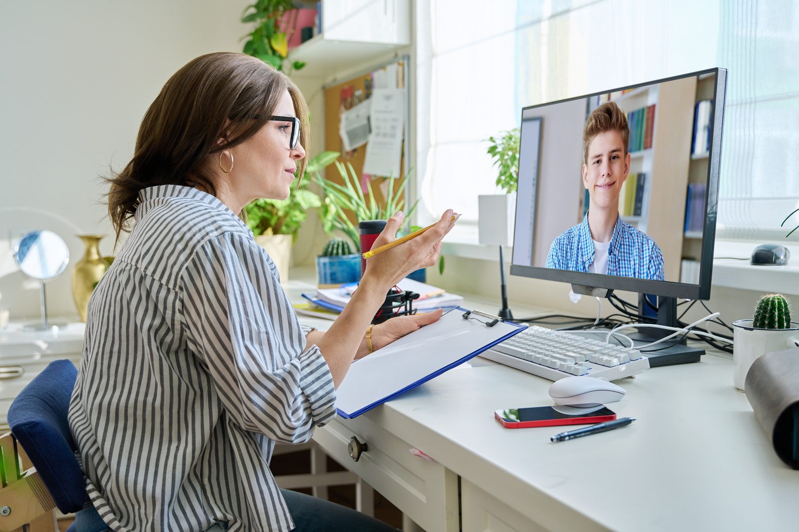 A life coach in a video coaching session with a teenager
